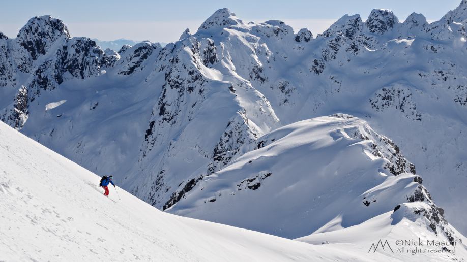 25 Ian Scorah dwarfed by the surrounding peaks as he descends Trollsadelen